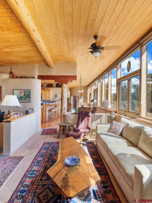 living room with beamed ceiling, wood ceiling, and ceiling fan