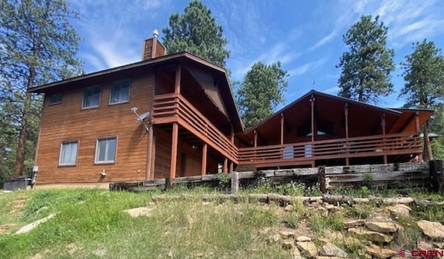 back of property with a chimney