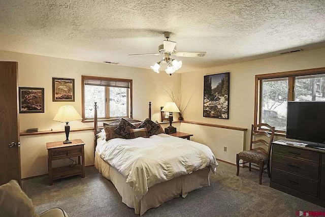 bedroom featuring baseboards, carpet floors, a textured ceiling, and ceiling fan