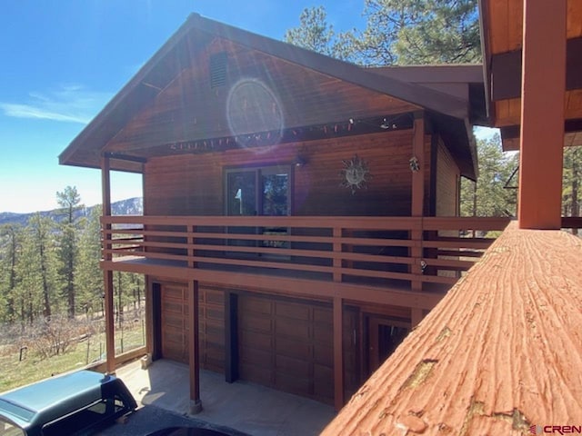 exterior space with a garage and a wooden deck