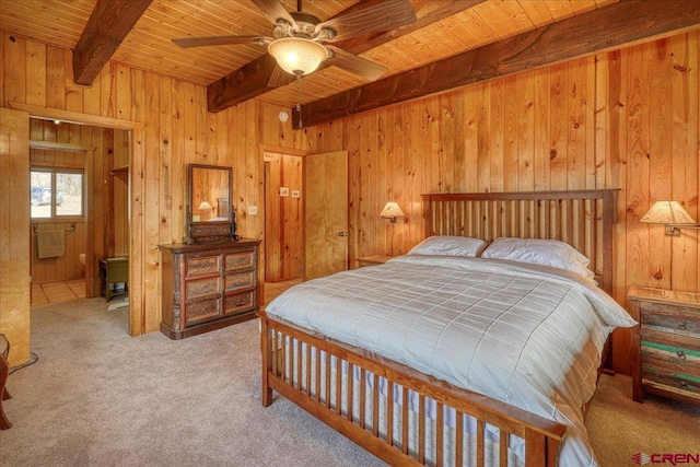 carpeted bedroom featuring beam ceiling, wooden walls, and wooden ceiling