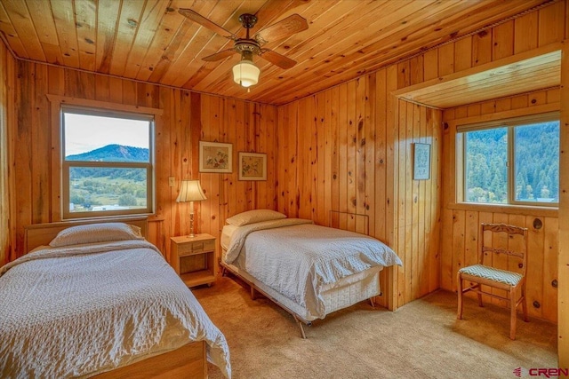 bedroom with light carpet, wooden ceiling, and a ceiling fan