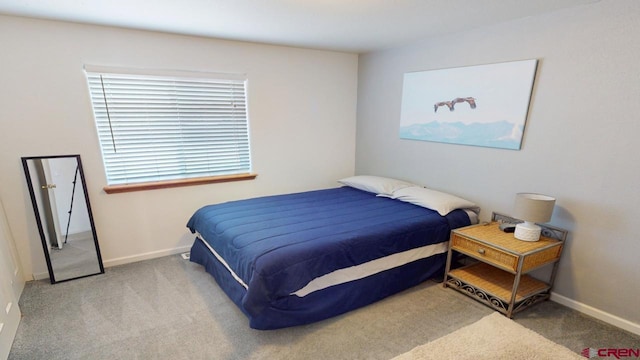 carpeted bedroom featuring baseboards