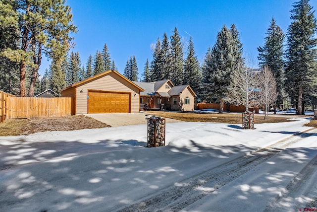 view of front of house with concrete driveway and fence