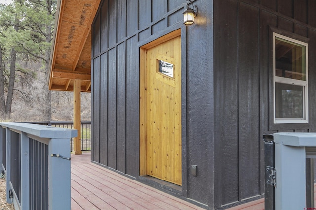 entrance to property featuring board and batten siding and a deck