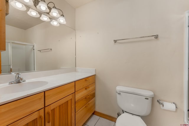 full bathroom featuring tile patterned floors, a shower stall, vanity, and toilet