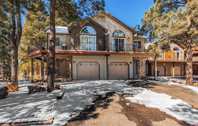 rustic home featuring driveway and an attached garage