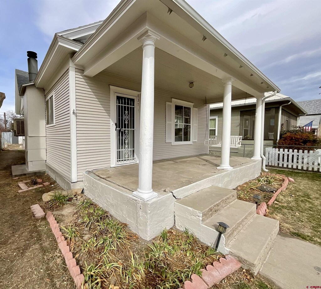 837 Palmer St, Delta, CO 81416 - exterior space with covered porch and a chimney