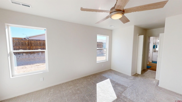 3601 Tinker Dr, Aztec, NM 87410 - unfurnished room featuring a ceiling fan, light colored carpet, visible vents, and baseboards