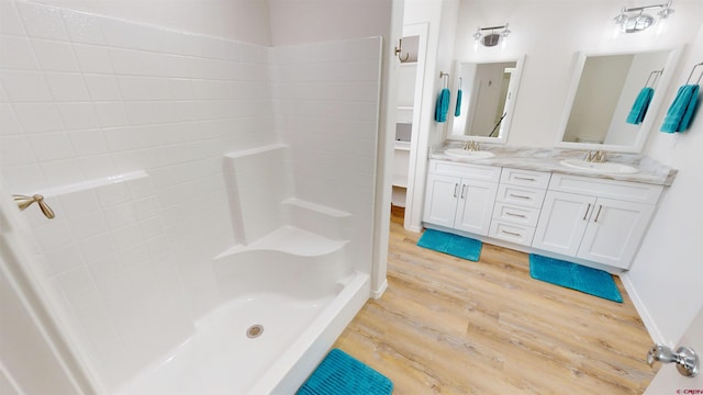 3601 Tinker Dr, Aztec, NM 87410 - bathroom featuring a sink, walk in shower, wood finished floors, and double vanity
