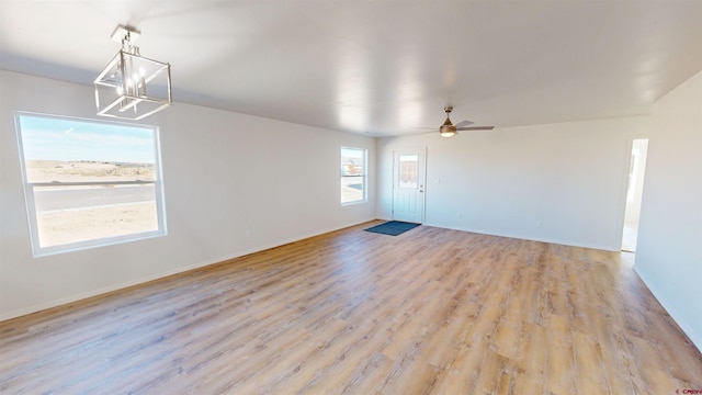 3601 Tinker Dr, Aztec, NM 87410 - interior space with baseboards, ceiling fan with notable chandelier, and light wood finished floors