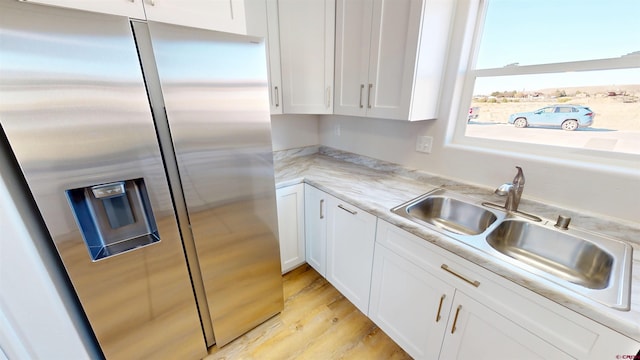 3601 Tinker Dr, Aztec, NM 87410 - kitchen featuring a sink, light wood-type flooring, stainless steel fridge with ice dispenser, and white cabinetry