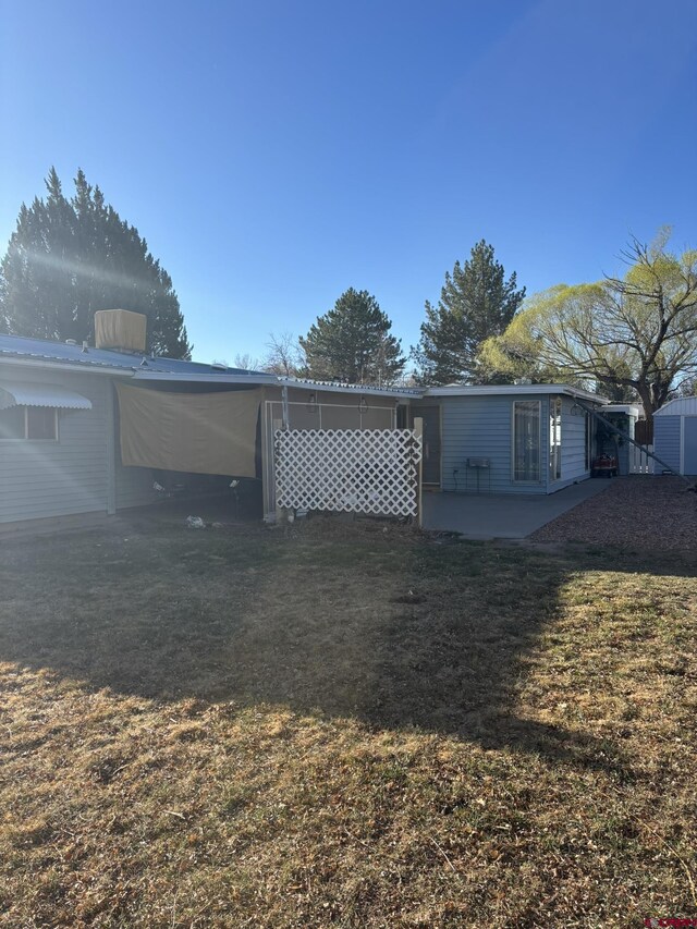745 Hartig St, Delta, CO 81416 - back of property featuring a patio area and a lawn