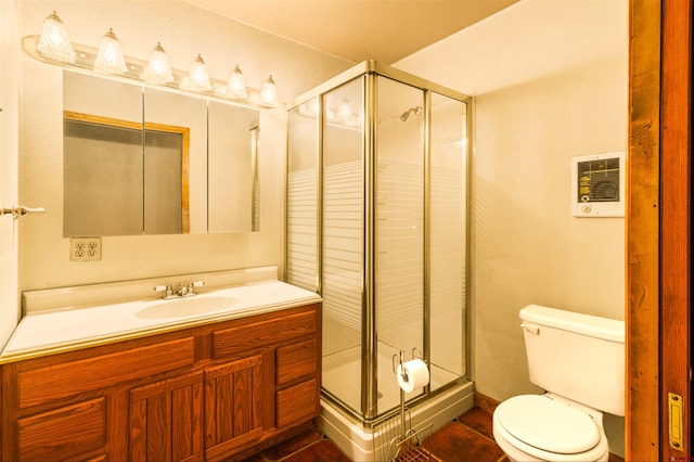 full bath featuring vanity, toilet, and a shower stall