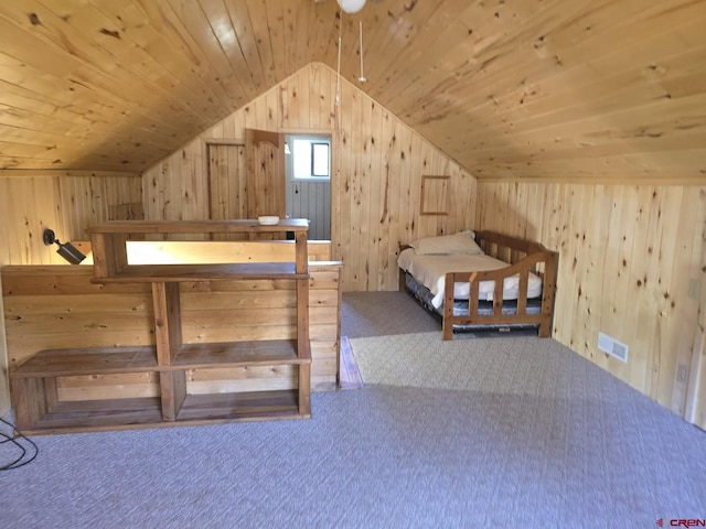 unfurnished bedroom featuring wooden walls, wooden ceiling, and carpet floors