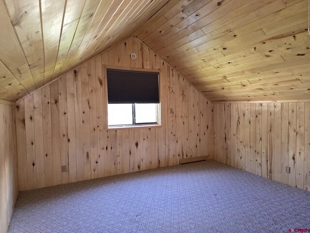 bonus room featuring wooden walls, wooden ceiling, and vaulted ceiling