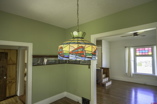 1003 San Juan St, Trinidad, CO 81082 - unfurnished dining area featuring wood finished floors, baseboards, and ceiling fan