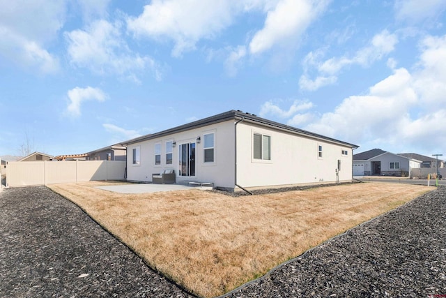 2305 Mountain Pines Dr, Montrose, CO 81401 - rear view of property featuring a lawn, stucco siding, fence, and a patio area