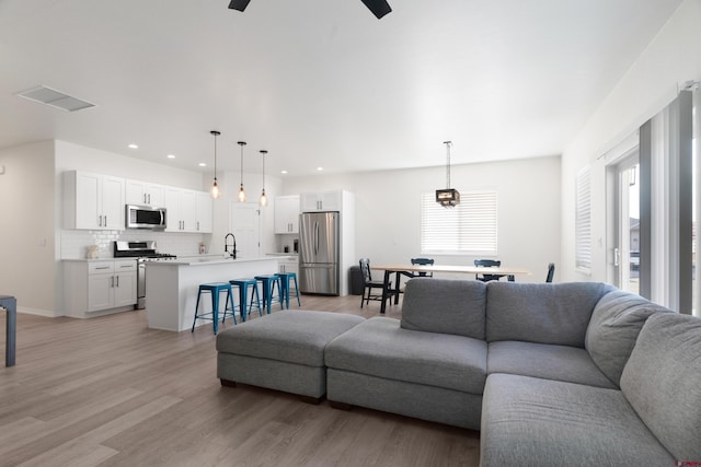 2305 Mountain Pines Dr, Montrose, CO 81401 - living room with a ceiling fan, recessed lighting, baseboards, and light wood-type flooring