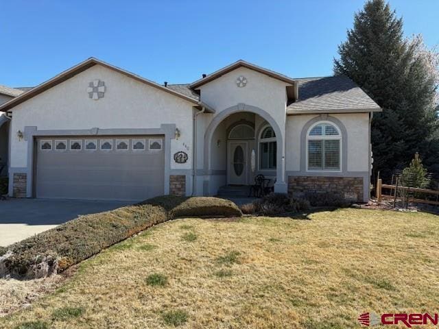 440 Old Goat Trl, Cedaredge, CO 81413 - view of front facade featuring stone siding, concrete driveway, stucco siding, an attached garage, and a front lawn