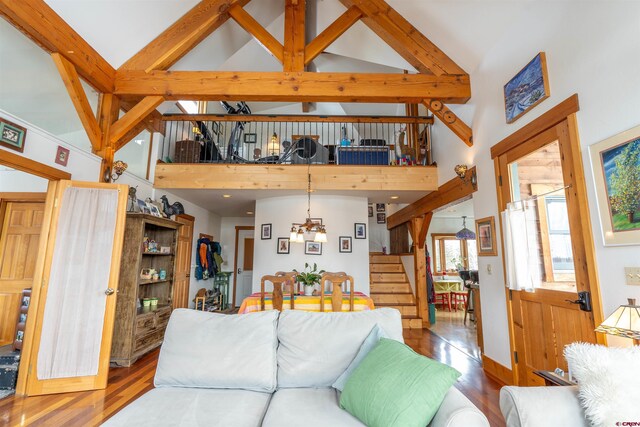407 Cascadilla St, Crested Butte, CO 81224 - living area with high vaulted ceiling, wood finished floors, stairs, and a chandelier