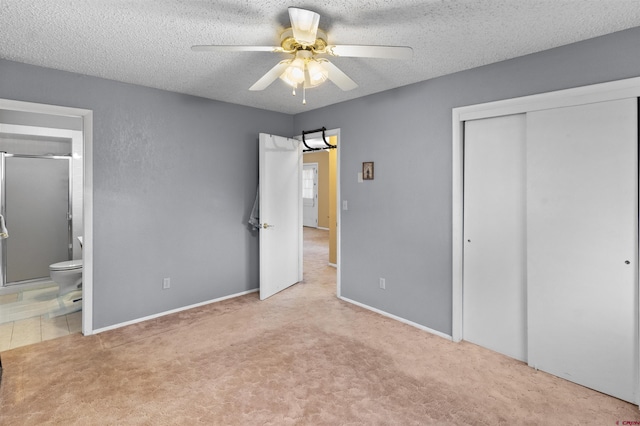 801 S Nevada Ave, Montrose, CO 81401 - unfurnished bedroom with connected bathroom, a closet, carpet floors, a ceiling fan, and a textured ceiling