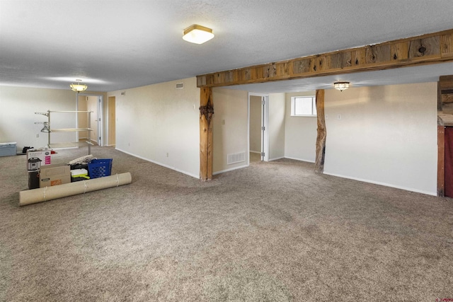 801 S Nevada Ave, Montrose, CO 81401 - basement with baseboards, carpet floors, a textured ceiling, and visible vents