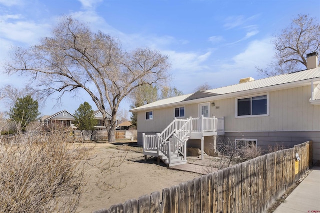 801 S Nevada Ave, Montrose, CO 81401 - back of house featuring a chimney, metal roof, and fence private yard