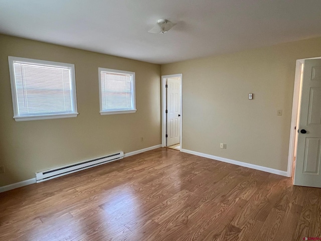 485 1740th Rd, Delta, CO 81416 - empty room with a baseboard radiator, wood finished floors, and baseboards