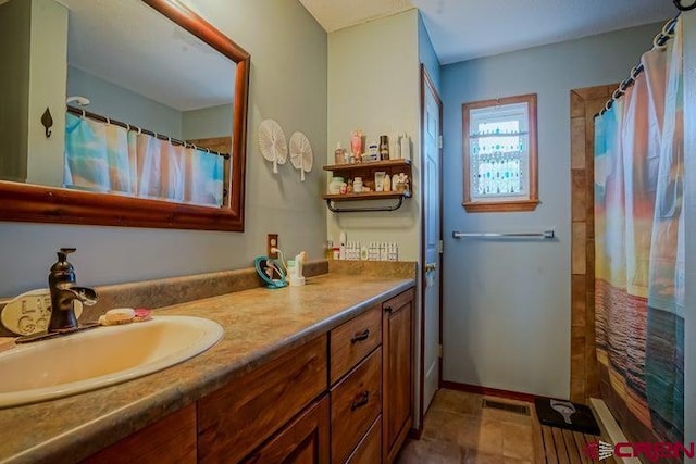 2 S Buffalo Dr, Walsenburg, CO 81089 - bathroom with vanity, curtained shower, baseboards, and visible vents