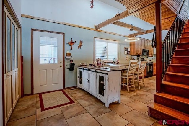 2 S Buffalo Dr, Walsenburg, CO 81089 - kitchen with light tile patterned flooring, a peninsula, and black microwave