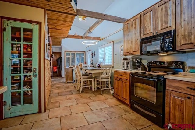 2 S Buffalo Dr, Walsenburg, CO 81089 - kitchen featuring black appliances, light countertops, brown cabinetry, and light tile patterned floors