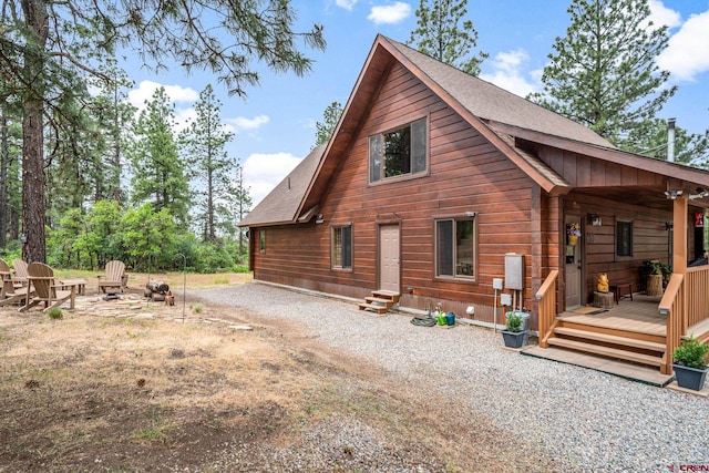 1838 Beaver Creek Dr, Bayfield, CO 81122 - rear view of property with a fire pit, a shingled roof, and entry steps