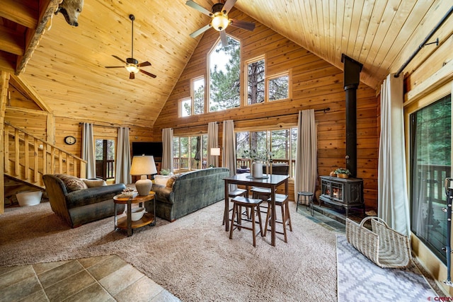 1838 Beaver Creek Dr, Bayfield, CO 81122 - dining area featuring wooden ceiling, stairway, wooden walls, a wood stove, and ceiling fan