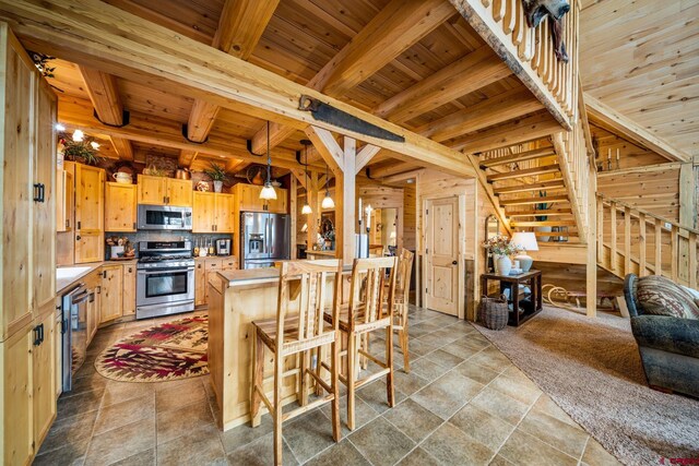 1838 Beaver Creek Dr, Bayfield, CO 81122 - kitchen with tasteful backsplash, wooden ceiling, stainless steel appliances, light brown cabinetry, and beam ceiling