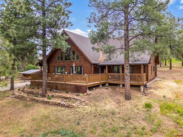 1838 Beaver Creek Dr, Bayfield, CO 81122 - rear view of house featuring roof with shingles and a wooden deck