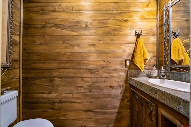 1838 Beaver Creek Dr, Bayfield, CO 81122 - bathroom featuring toilet, vanity, and wood walls