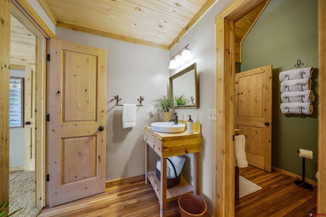 1838 Beaver Creek Dr, Bayfield, CO 81122 - bathroom featuring wood ceiling, hardwood / wood-style flooring, baseboards, and vanity