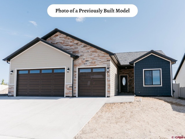 ranch-style home with stone siding, driveway, and a garage