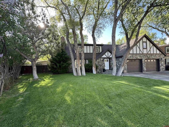 6 Mountain View Pl, Alamosa, CO 81101 - view of front of house featuring stone siding, an attached garage, and driveway