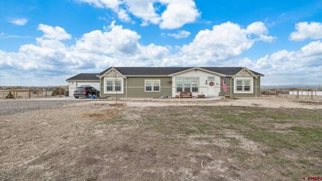 1241 Appaloosa St, Delta, CO 81416 - view of front facade with driveway, an attached garage, and fence