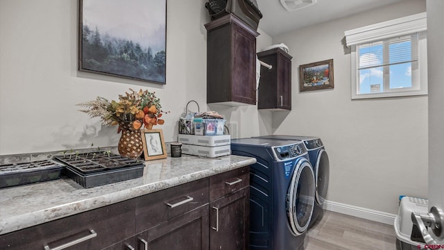 1241 Appaloosa St, Delta, CO 81416 - clothes washing area featuring baseboards, washing machine and clothes dryer, visible vents, light wood-style flooring, and cabinet space