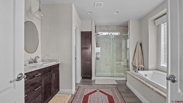 1241 Appaloosa St, Delta, CO 81416 - full bath featuring a bath, visible vents, a shower stall, wood finished floors, and vanity