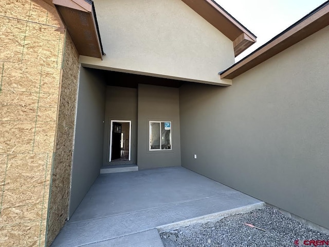 1533 Criterion St, Delta, CO 81416 - view of exterior entry with stucco siding and a patio area
