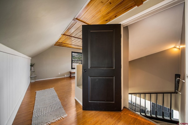 bonus room with baseboards, wooden ceiling, baseboard heating, wood finished floors, and lofted ceiling