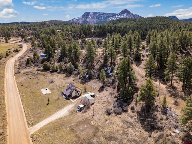 aerial view featuring a forest view and a mountain view