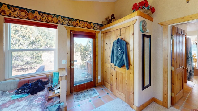 interior space with tile patterned floors and baseboards