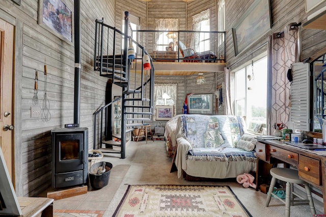 18725 Rd 25.8, Dolores, CO 81323 - carpeted living room with wood walls, a wood stove, stairway, and a high ceiling