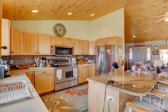 18725 Rd 25.8, Dolores, CO 81323 - kitchen with a kitchen breakfast bar, wood ceiling, appliances with stainless steel finishes, decorative backsplash, and light brown cabinets