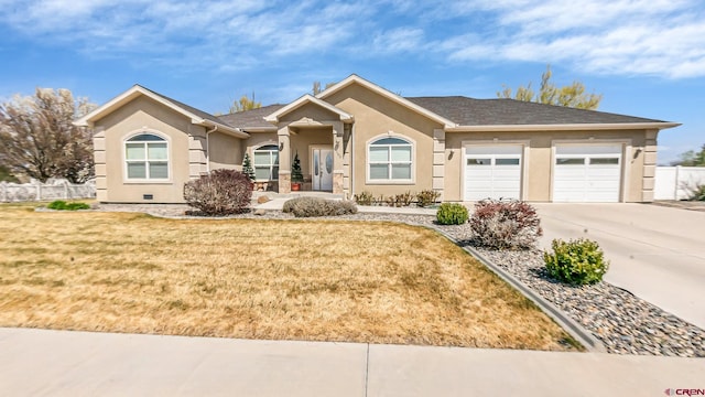 single story home with concrete driveway, fence, a garage, and stucco siding